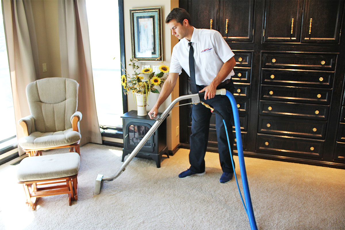 Carpet cleaning technician cleaning carpet in a bedroom at a home in Calgary